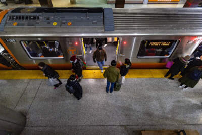 MBTA riders get on and off an Orange Line train in North Station. (Jesse Costa/WBUR)