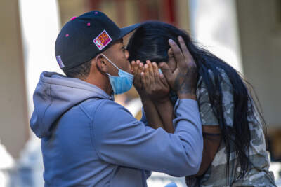 A young migrant couple embraces on the porch of St. Andrew’s Parish House in Edgartown, Martha's Vineyard. Nearly 50 Venezuelans were flown to the island from Texas under what they said was a false pretense. Florida Gov. Ron DeSantis took credit for flying the immigrants to Massachusetts.