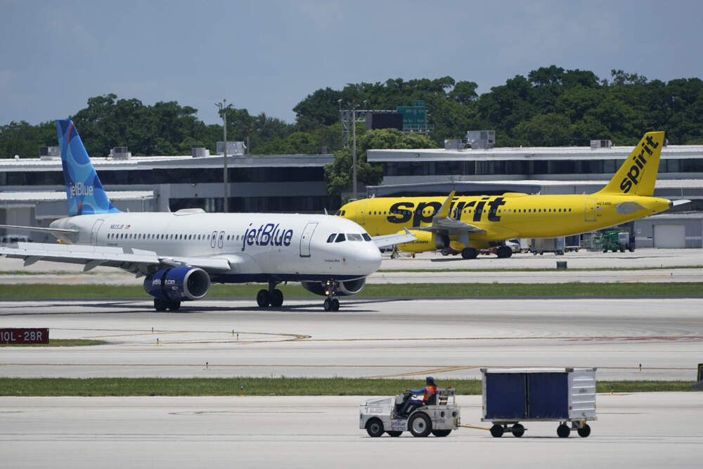 A JetBlue Airways Airbus A320, left, passes a Spirit Airlines Airbus A320 as it taxis on the runway, July 7, 2022, at the Fort Lauderdale-Hollywood International Airport in Fort Lauderdale, Fla. (Wilfredo Lee/AP)