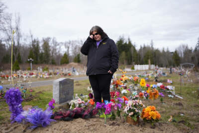 Evelyn Jefferson, a crisis outreach supervisor for Lummi Nation, stands at the grave of her son Patrick George Jr., who died last September due to an overdose of street drugs containing the synthetic opioid carfentanil, at the Lummi Nation cemetery on tribal reservation lands, Thursday, Feb. 8, 2024, near Bellingham, Wash. Jefferson had to wait a week to bury her son due to several other overdose deaths in the community. (Lindsey Wasson/AP)
