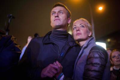 Russian opposition leader Alexei Navalny, left, and his wife Yulia after a rally in rain-soaked Moscow, Russia. (Evgeny Feldman/AP)
