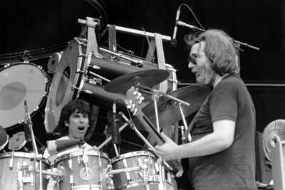The Grateful Dead open up the final day of the US Festival in San Bernardino, Ca. early Sunday morning on Sept. 5, 1982. Guitarist Jerry Garcia, right, and drummer Mickey Hart play music spanning two decades to an enthusiastic crowd of rock and roll fans.  (Lennox Mclendon/AP)