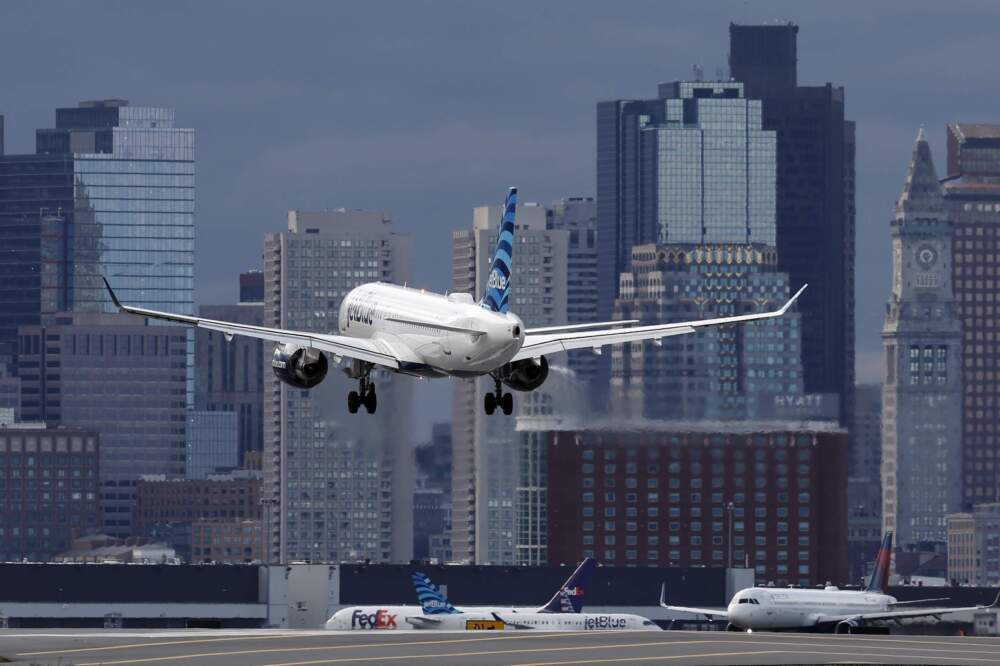 A JetBlue plane lands at Logan International Airport in Boston. (Michael Dwyer/AP)
