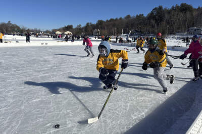 Hockey players from team Boston Beauties go for the puck during the final of the women's open division at the Pond Hockey Classic in Meredith, N.H., on Sunday, Feb. 4, 2024. (Nick Perry/AP)