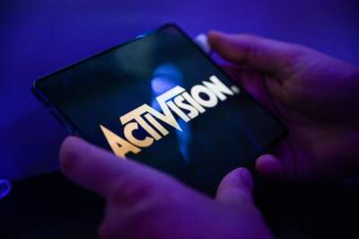 A visitor plays the game 'Call of Duty' of Activision on a mobile phone. (Ina Fassbender/AFP via Getty Images)