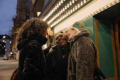 Friends socialize outside a movie theater. (Getty Images)