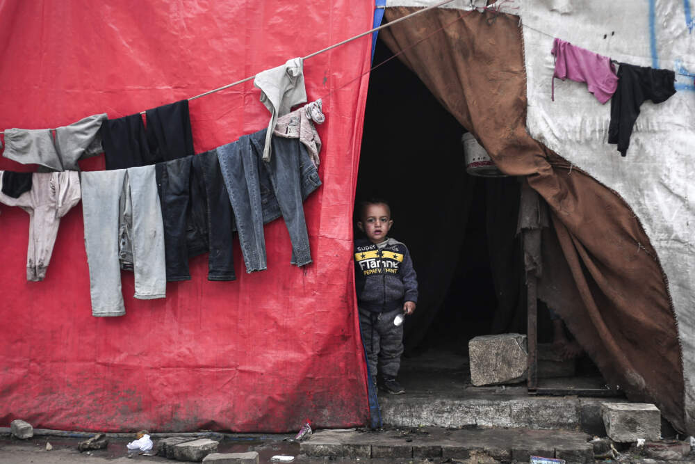 A Palestinian boy stands in his tent at a refugee camp in Rafah in the southern Gaza Strip on Feb. 27, 2024, as battles between Israel and the Palestinian militant group Hamas continue. (AFP via Getty Images)