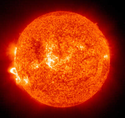 In this handout photo provided by NASA, a Solar and Heliospheric Observatory image shows Region 486 that unleashed a a solar flare (lower left) from Nov. 18, 2003 on the sun. (NASA via Getty Images)