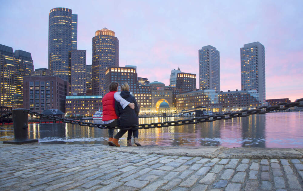 A couple enjoying Boston Harbor at sunset. (Grant Faint/Getty Images)