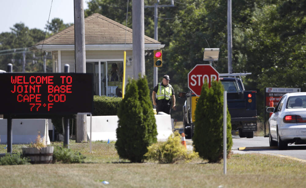 Vehicles are stopped by security personnel as they enter a gate at Joint Base Cape Cod. (Steven Senne/AP)