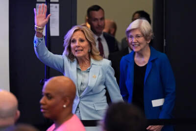 First lady Jill Biden waves while introduced with Sen. Elizabeth Warren during a discussion on women's health research, on Feb. 21, in Cambridge, Massachusetts. (Charles Krupa/AP)