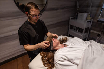 In the name of journalism, the reporter undergoes a sleep treatment with massage therapist Tyler Cousins at the Four Seasons in Boston's Back Bay. (Jesse Costa/WBUR)