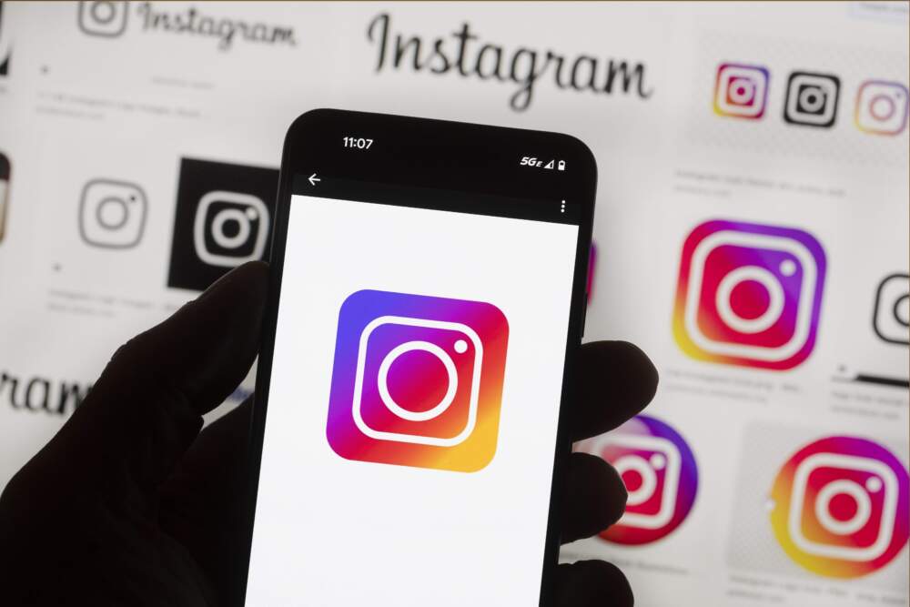 The Instagram logo is seen on a cell phone. New app settings allow users to opt out of limiting political content on their feed. (Michael Dwyer/AP)