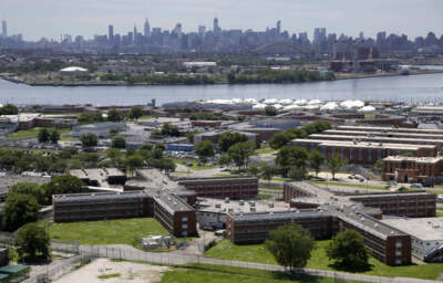 The Rikers Island jail complex stands in New York with the Manhattan skyline in the background. (Seth Wenig/AP)