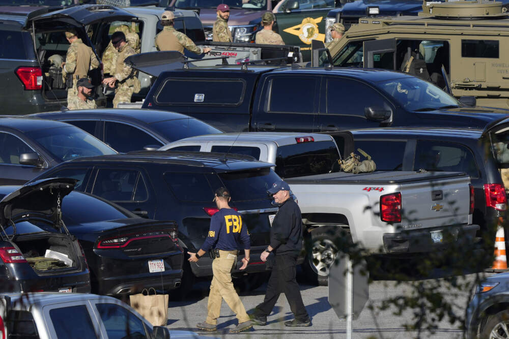 Law enforcement personnel are staged in a school parking lot during a manhunt for Robert Card in the aftermath of a mass shooting in Lewiston, Maine, Oct. 27, 2023. (Matt Rourke/AP)