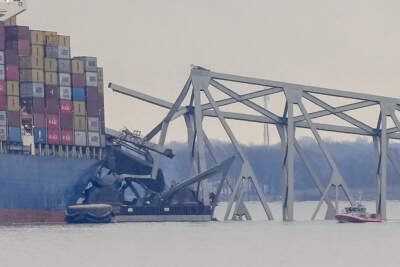 A container ship rests against wreckage of the Francis Scott Key Bridge. (Matt Rourke/AP)