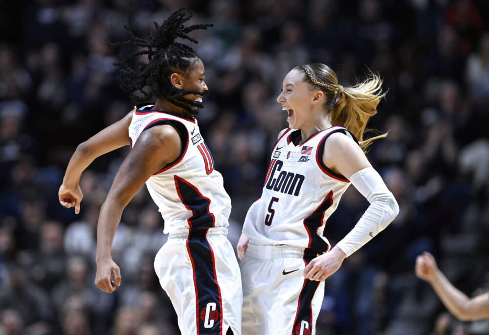 UConn guards KK Arnold, left, and Paige Bueckers, right, celebrate during the first half of an NCAA college basketball game against Georgetown in the finals of the Big East Conference tournament at Mohegan Sun Arena, Monday, March 11, 2024, in Uncasville, Conn. (Jessica Hill/AP)