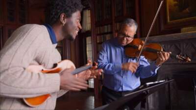 Violinists Jonathan Frelix (left) and Ilmar Gavilan (right) play St. Albans ensemble by Sawney Freeman, at the Waveny House in New Canaan, Connecticut. (Ayannah Brown/Connecticut Public)