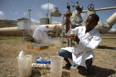 Kengen workers test a sample of condensed steam at a separator unit of a super heated steam well at the Olkaria geothermal plant located near the central Kenyan town of Naivasha. (Roberto Schmidt/AFP via Getty Images)