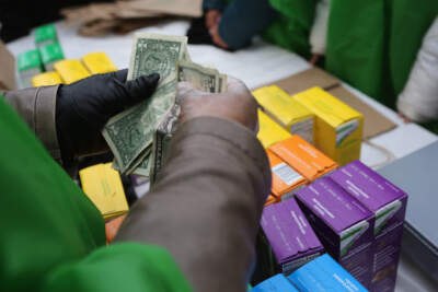 Money is collected as Girl Scouts sell cookies.  (John Moore/Getty Images)