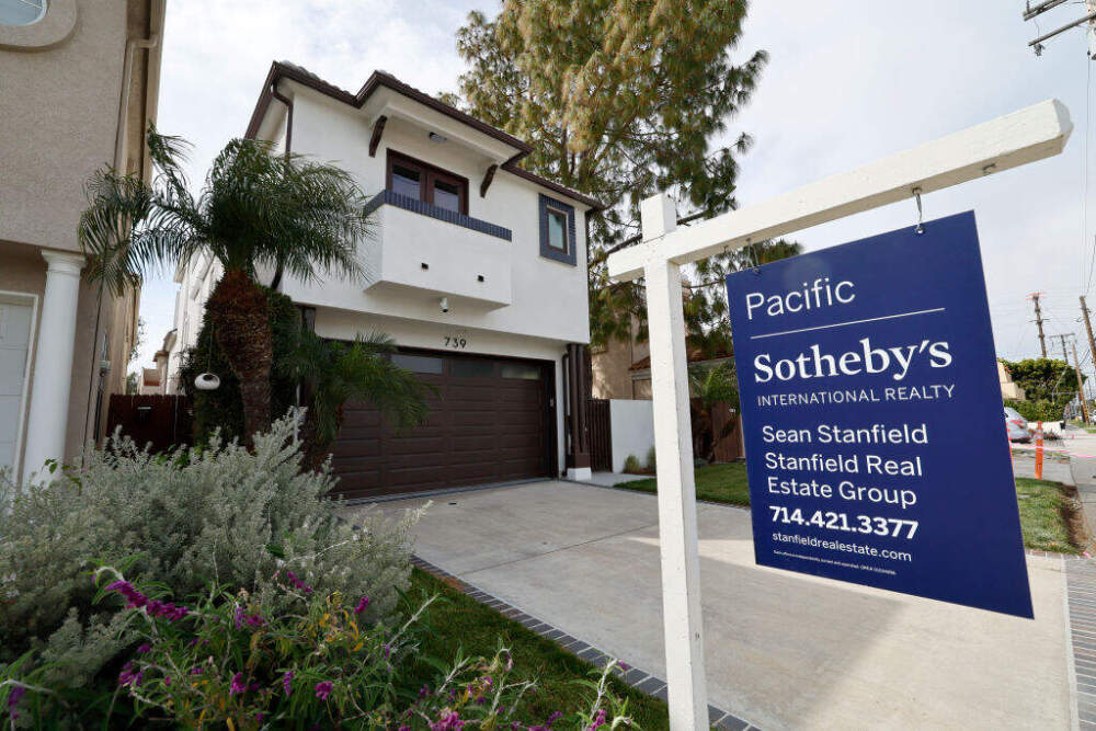 A home for sale sign in front of a house in Huntington Beach.   (Allen J. Schaben / Los Angeles Times via Getty Images)