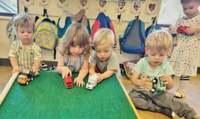 Preschool students play with cars. (Courtesy of Martha Heineman Pieper)