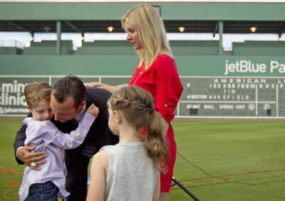 Boston Red Sox pitcher Tim Wakefield hugs his son Trevor as his wife Stacy and daughter Brianna look on in 2012. (David Goldman/AP)