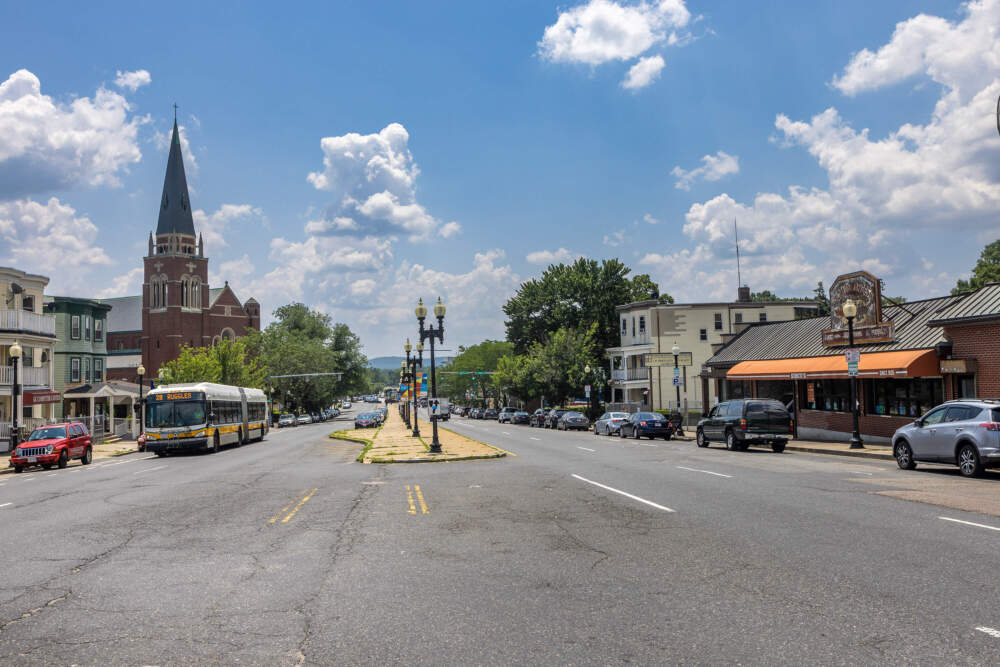 On the left, the St Angela Merici Church, and on the right, Simco’s, looking down Blue Hill Avenue into Mattapan Square. (Jesse Costa/WBUR)
