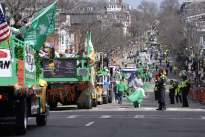 Floats and vehicles make their way along the parade route as spectators watch during the St. Patrick's Day parade on Sunday, March 17 in South Boston. (Steven Senne/AP)