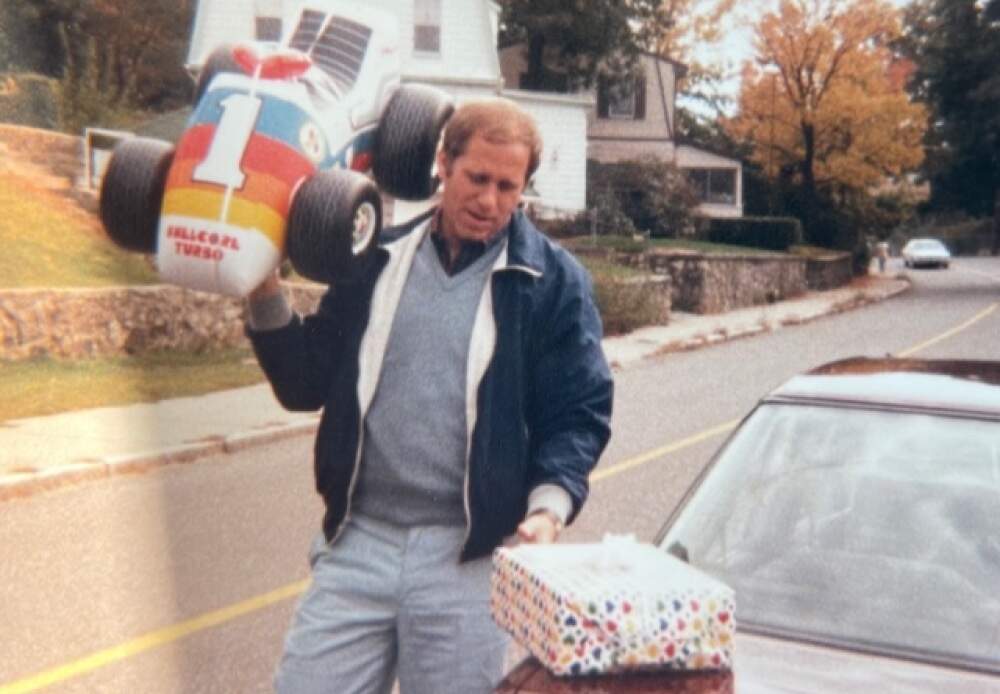 The author's uncle, Rick Fentin, carrying a gift of a Shellcore Turbo racecar for the author's first birthday. (Courtesy David Tanklefsky)