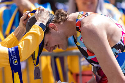 David French, of Denver, Colorado, receives his medal after finishing the Boston Marathon. (Jesse Costa/WBUR)