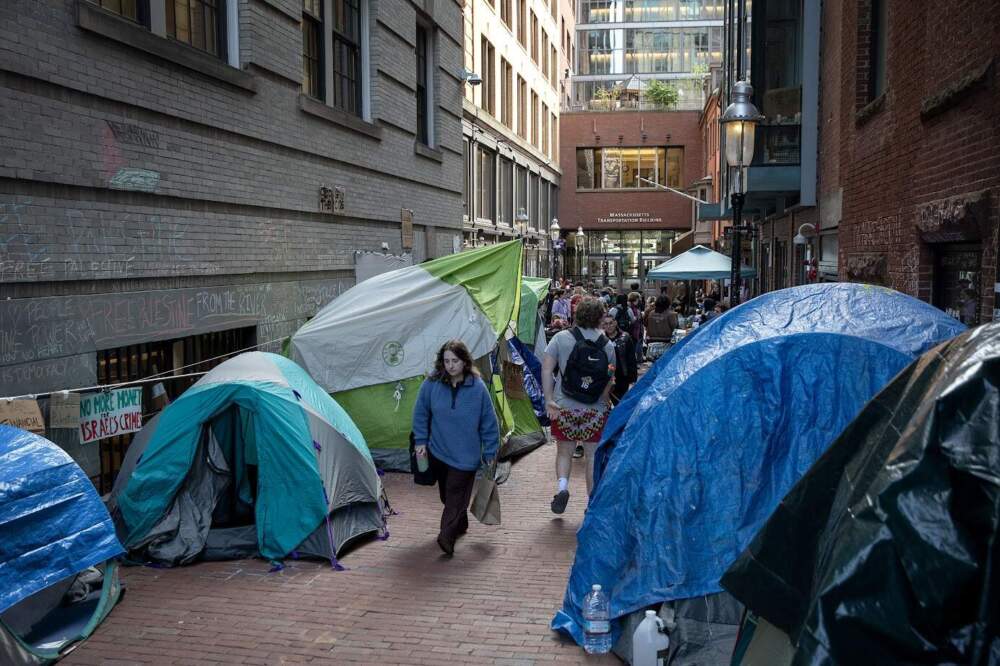 People walk through the Emerson student protest encampment at Boylston Place on Wednesday, April 24, 2024. (Robin Lubbock/WBUR)