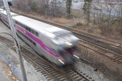 An MBTA Commutter Rail train barrels down the tracks on it's way to Boston. (Jesse Costa/WBUR)