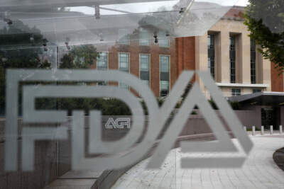 U.S. Food and Drug Administration building behind FDA logos at a bus stop on the agency's campus in Silver Spring, Md. (Jacquelyn Martin/AP)