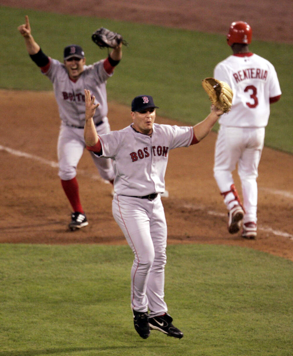 In this Oct. 27, 2004 file photo Boston Red Sox pitcher Keith Foulke, center, and first baseman Doug Mientkiewicz, left, celebrate after St. Louis Cardinals' Edgar Renteria (3) grounded out to end the ninth inning and give Boston a 3-0 win and a sweep of the World Series in St. Louis. (Mark Humphrey/AP)