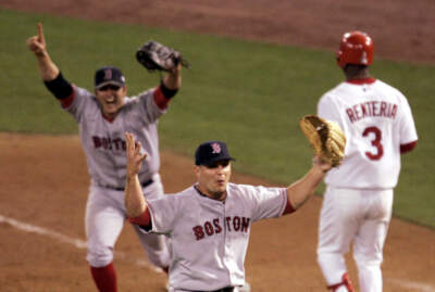 In this Oct. 27, 2004 file photo Boston Red Sox pitcher Keith Foulke, center, and first baseman Doug Mientkiewicz, left, celebrate after St. Louis Cardinals' Edgar Renteria (3) grounded out to end the ninth inning and give Boston a 3-0 win and a sweep of the World Series in St. Louis. (Mark Humphrey/AP)