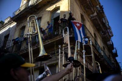 Members of the The Soul Rebels Band from New Orleans raise their instruments to the sky during the music conga through the streets of Old Havana during the 35th Havana Jazz Plaza festival. (Ramon Espinosa/AP)