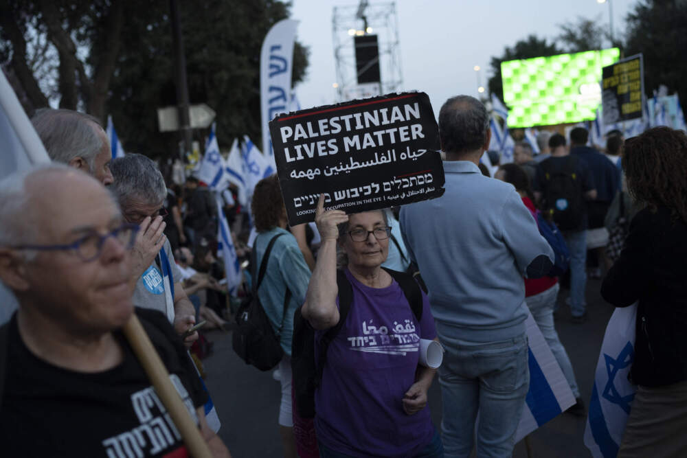 A woman holds up a sign that reads in English 'Palestinians Lives Matter', during a protest against Israeli Prime Minister Benjamin Netanyahu's government and call for the release of hostages held in the Gaza Strip. (Leo Correa/AP)