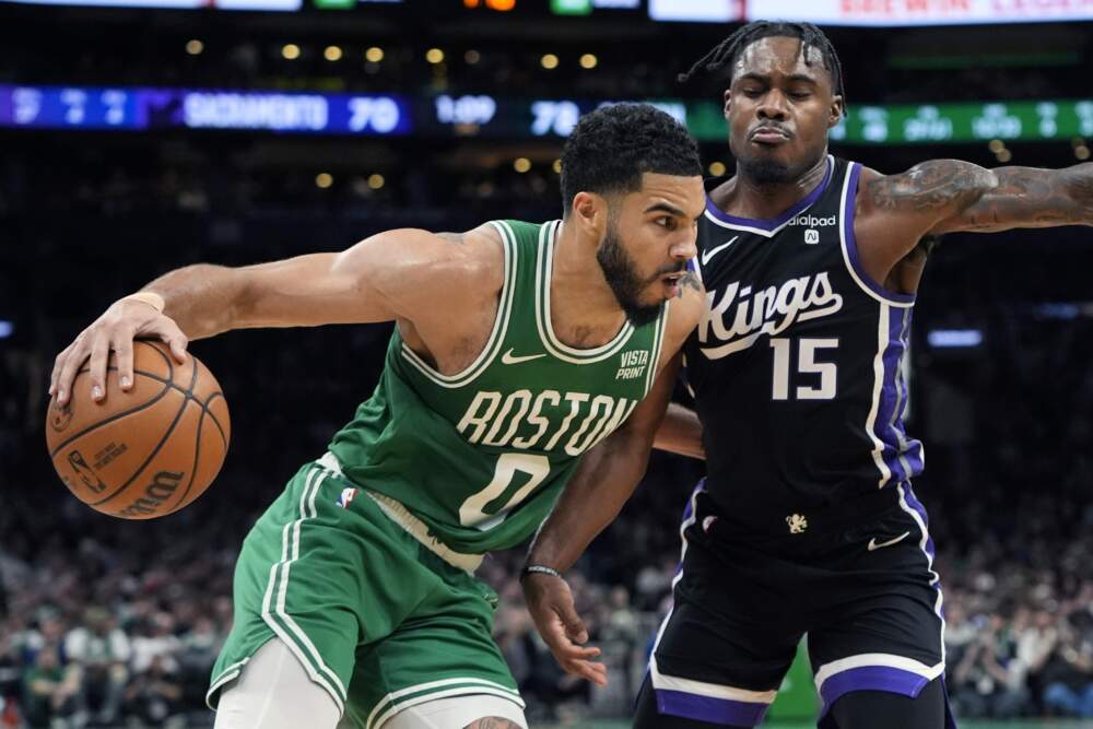 Boston Celtics' Jayson Tatum drives past Sacramento Kings' Davion Mitchell during the second half of an NBA basketball game Friday, April 5, 2024, in Boston. (Michael Dwyer/AP)