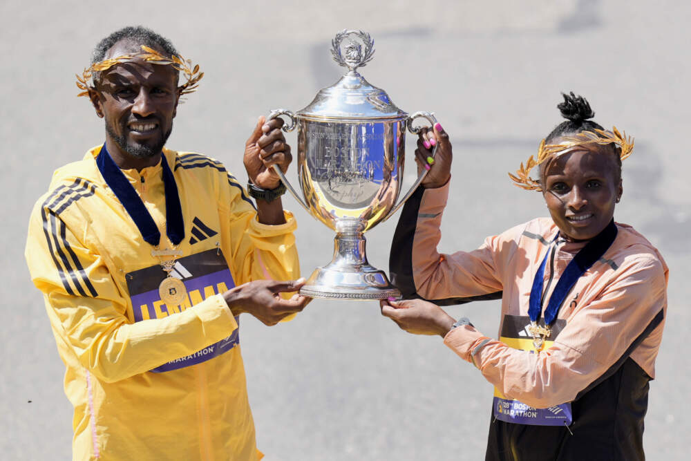 Boston Marathon men's division winner Sisay Lemma, of Ethiopia, and women's division winner Hellen Obiri, of Kenya hold up the trophy at the Boston Marathon on April 15, 2024. (Charles Krupa/AP)