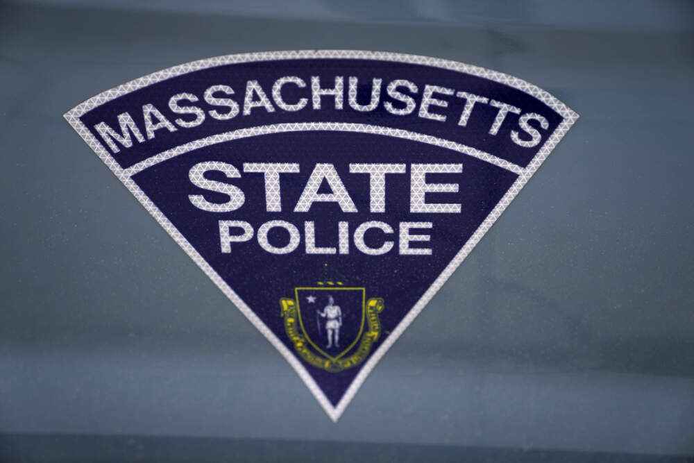 The seal of the Commonwealth of Massachusetts is displayed on a Massachusetts State Police cruiser in Boston. (Charles Krupa/AP)