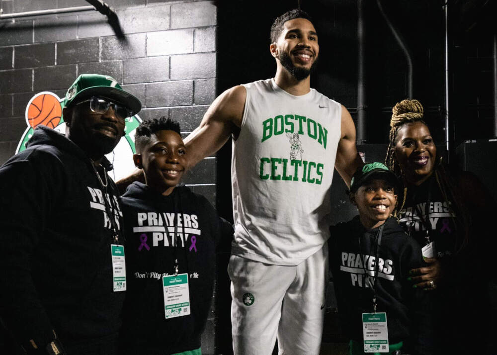 Tiarih King, 9, (second from right) of Dorchester, had his wish to meet Celtics star Jayson Tatum granted on April 11 in the TD Garden by the Make-A-Wish Foundation of Massachusetts and Rhode Island. He is pictured here with his father, Shawn, his brother, Tavaj, Tatum, and his mother, Kueen. (Boston Celtics via Dorchester Reporter)