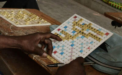 In some African countries, Scrabble is more than a game — it's a sport. Here, a Senegalese player sits in front of his board during a competition. (Seyllou/AFP via Getty Images)