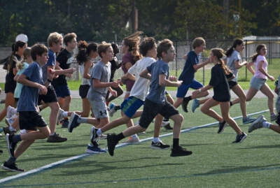 Middle school cross-country runners take off in a group training session. (Michael S. Williamson/The Washington Post via Getty Images)