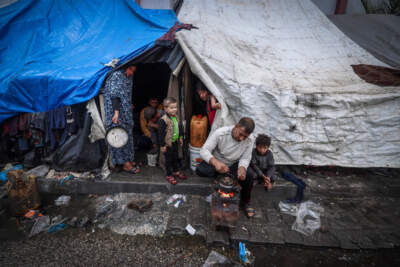 A displaced man makes tea in front of a tents beside a street on the first day of the Eid al-Fitr festival, marking the end of the holy month of Ramadan, in Rafah, southern Gaza Strip, on April 10, 2024, amid the ongoing conflict between Israel and the Palestinian militant group Hamas. (Mohammed Abed/AFP via Getty Images)