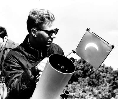 Ronald Cody, a second year graduate student in physics at Rutgers, uses a telescope to view the total solar eclipse in Nantucket, on March 7, 1970. (Bill Ryerson/The Boston Globe via Getty Images)