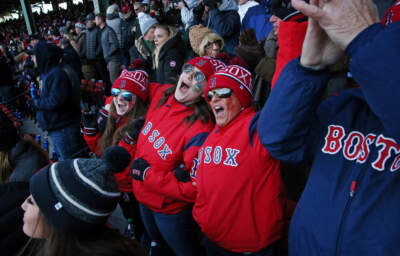 Fans sing &quot;Take Me Out to the Ball Game&quot; during the seventh-inning stretch at Fenway Stadium on April 5, 2018. (Craig F. Walker/The Boston Globe via Getty Images)
