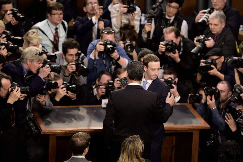 TOPSHOT - Facebook CEO Mark Zuckerberg arrives to testify before a joint hearing of the US Senate Commerce, Science and Transportation Committee and Senate Judiciary Committee on Capitol Hill, April 10, 2018 in Washington, DC. Zuckerberg, making his first formal appearance at a Congressional hearing, seeks to allay widespread fears ignited by the leaking of private data on tens of millions of users to British firm Cambridge Analytica working on Donald Trump's 2016 presidential campaign. (Photo by Brendan Smialowski / AFP) (Photo by BRENDAN SMIALOWSKI/AFP via Getty Images)
