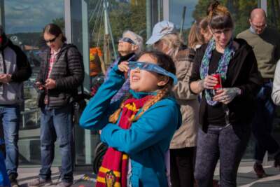 Visitors at ECHO, Leahy Center for Lake Champlain view the partial eclipse on October 14, 2023. (Courtesy ECHO, Leahy Center)