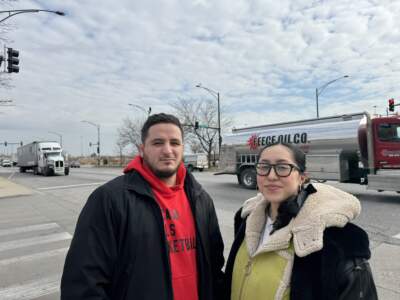 José Miguel Acosta Córdova and Paulina Vaca stand at the intersection of Pulaski Road and 41st Street in Chicago's Archer Heights neighborhood. A recent study found that over 24 hours, more than 5,000 trucks and buses pass through this spot. (Juanpablo Ramirez-Franco/WBEZ)